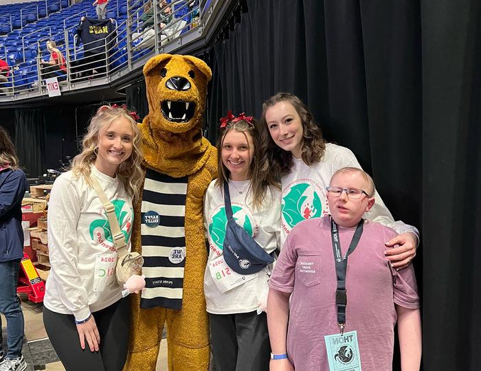 Neya, Caroline, Taylor, and the Nittany Lion with Neya’s younger brother, Collin, a cancer survivor and Four Diamonds child